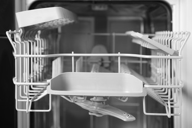 Photo of Open clean modern empty automatic dishwasher machine, closeup