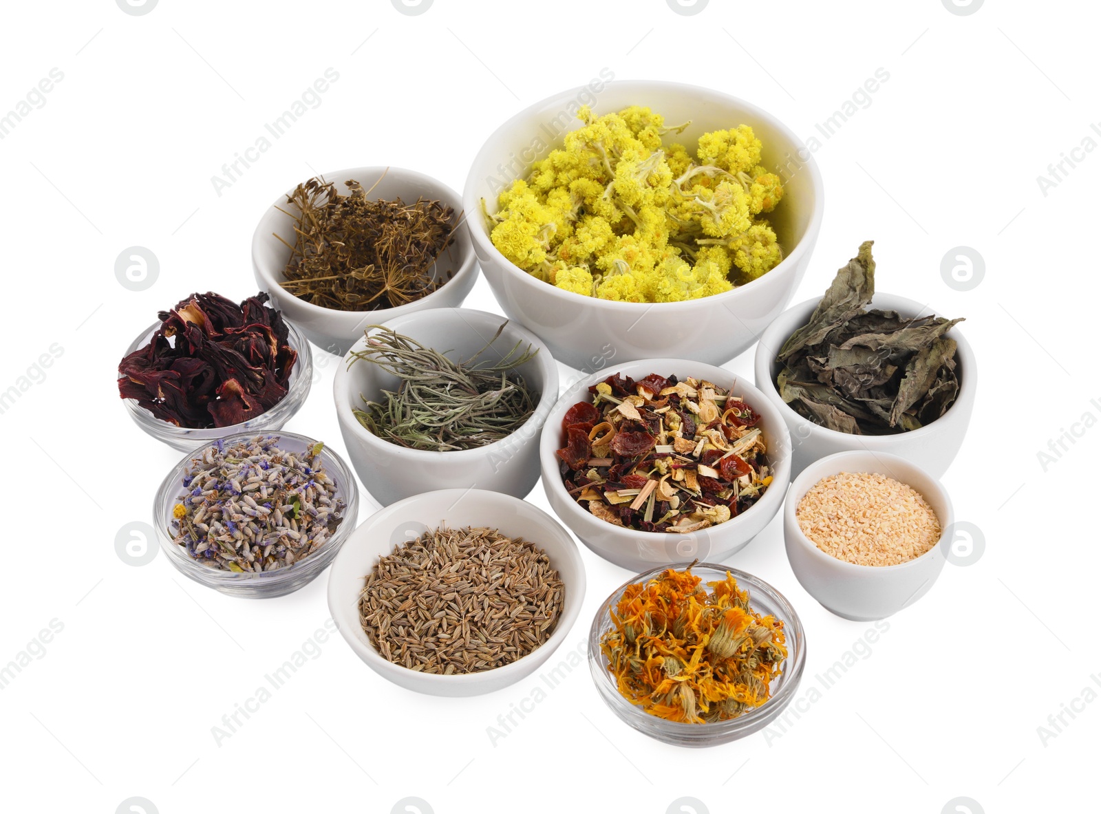 Photo of Many different dry herbs and flowers in bowls isolated on white