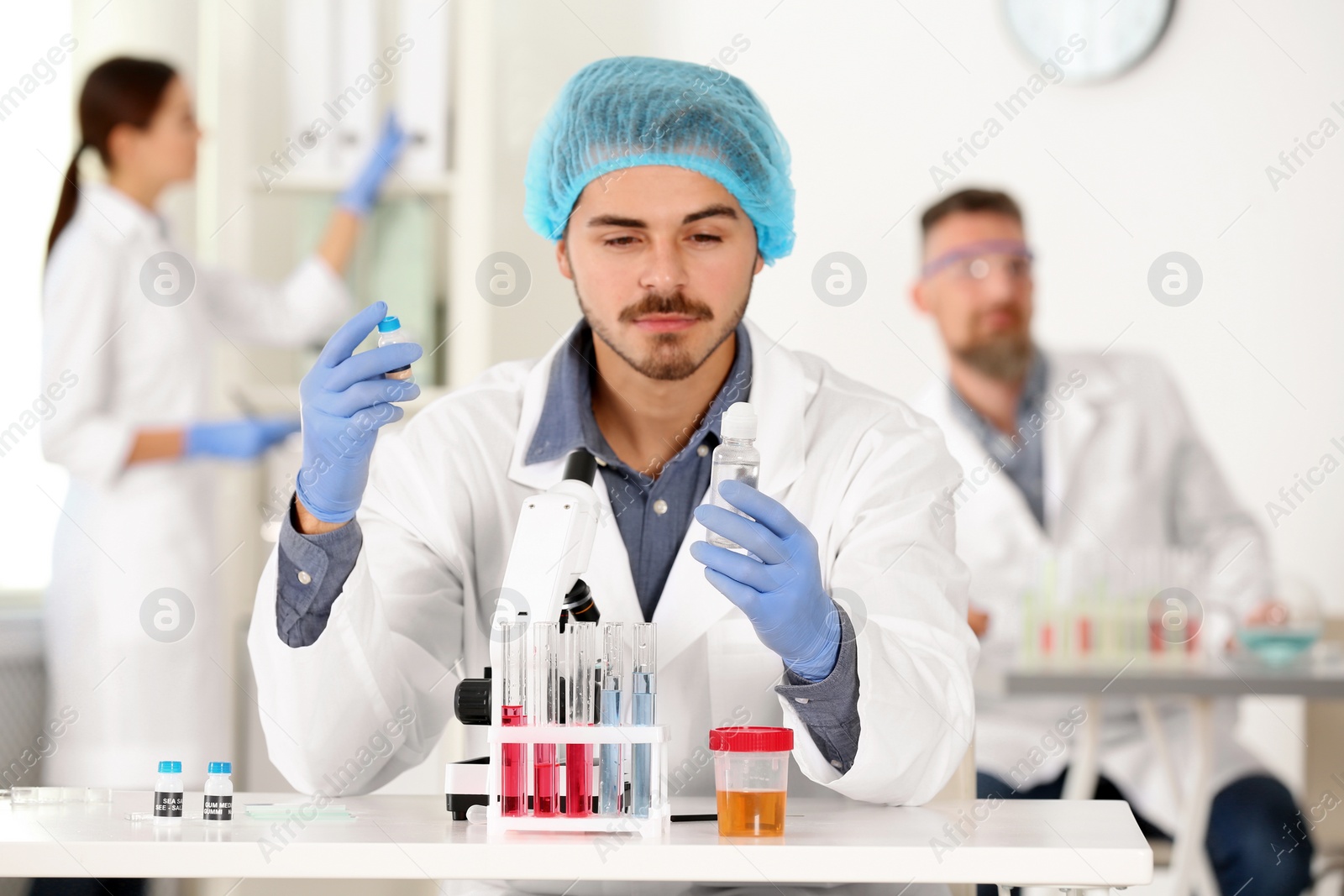 Photo of Male scientist working at table in laboratory. Research and analysis