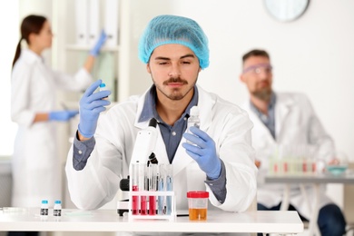 Male scientist working at table in laboratory. Research and analysis