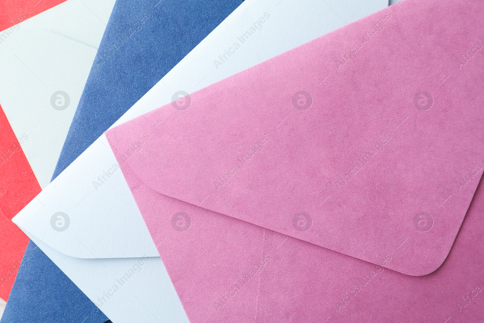 Photo of Colorful paper envelopes as background, top view