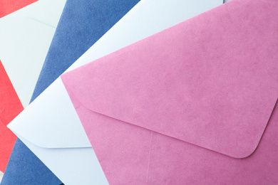 Photo of Colorful paper envelopes as background, top view