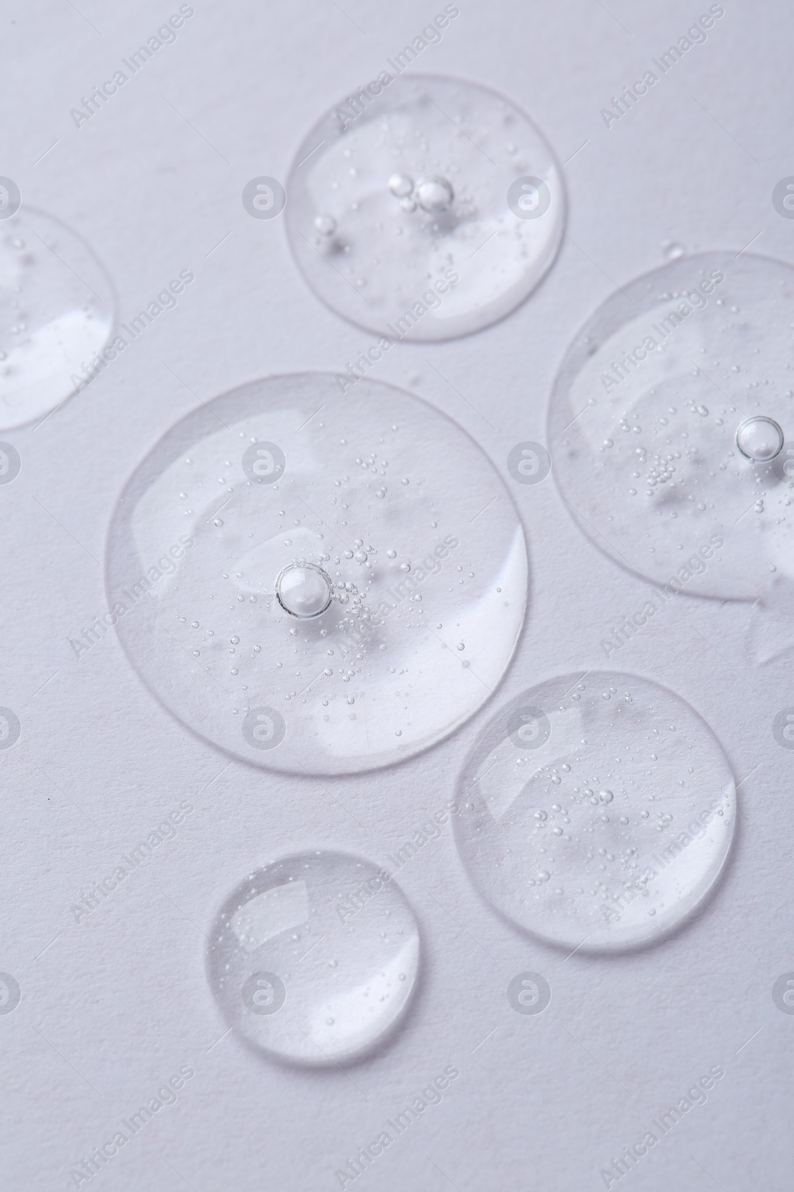 Photo of Samples of cosmetic serum on white background, above view