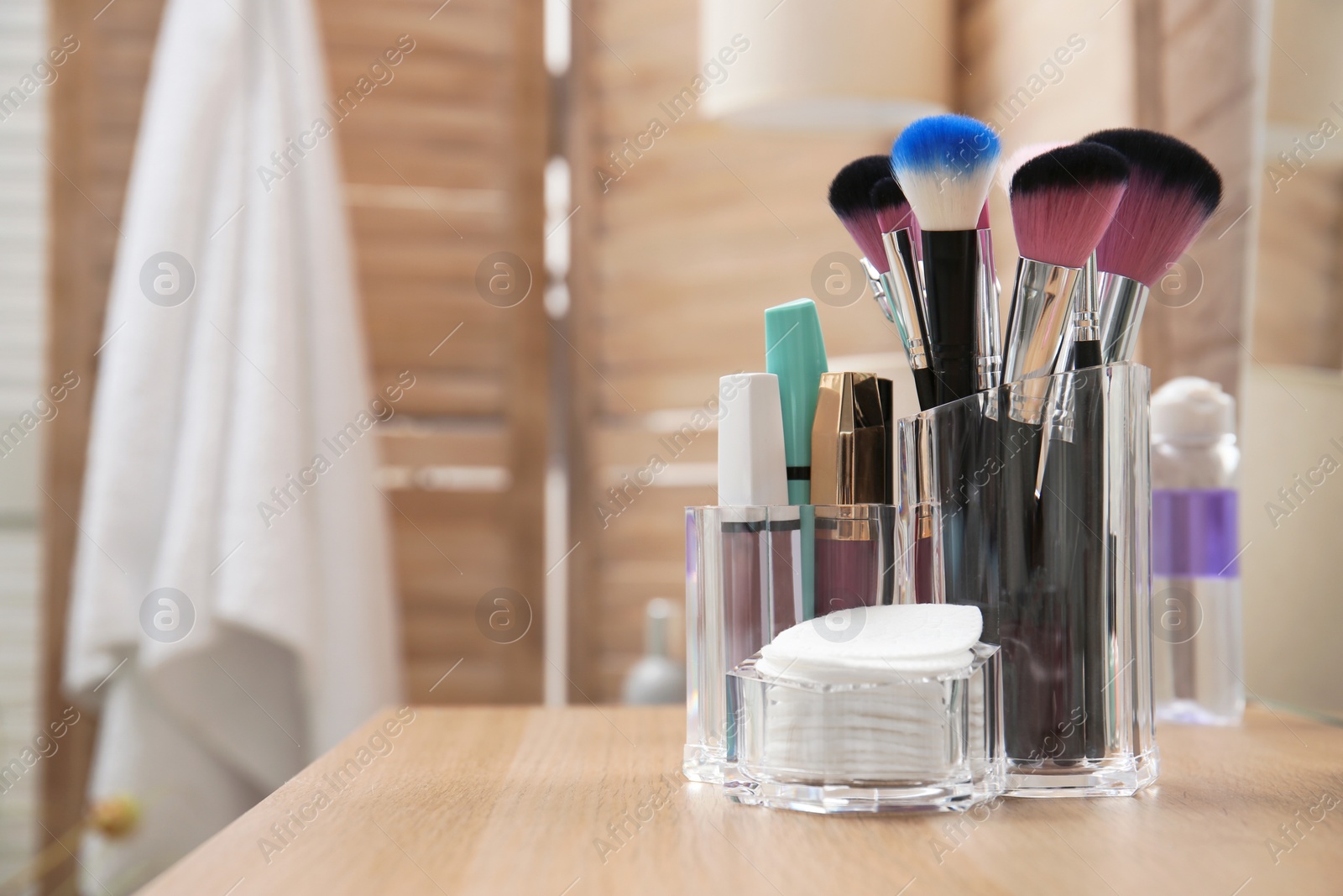 Photo of Organizer with makeup cosmetic products and space for text on dressing table