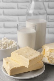 Photo of Tasty homemade butter and dairy products on white textured table