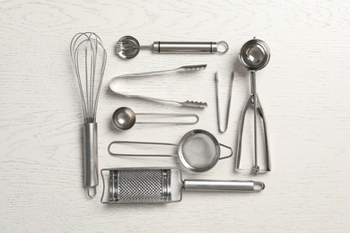 Cooking utensils on white wooden table, flat lay