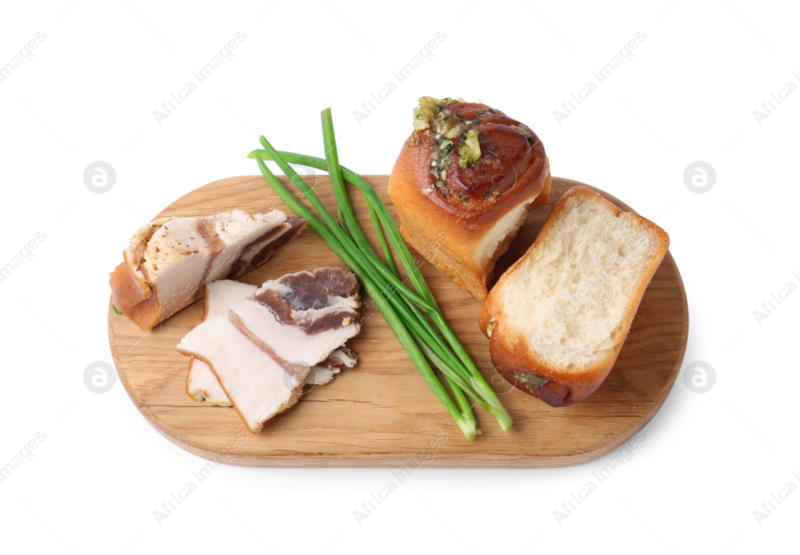 Photo of Board with delicious pampushky (buns), salo and green onions isolated on white