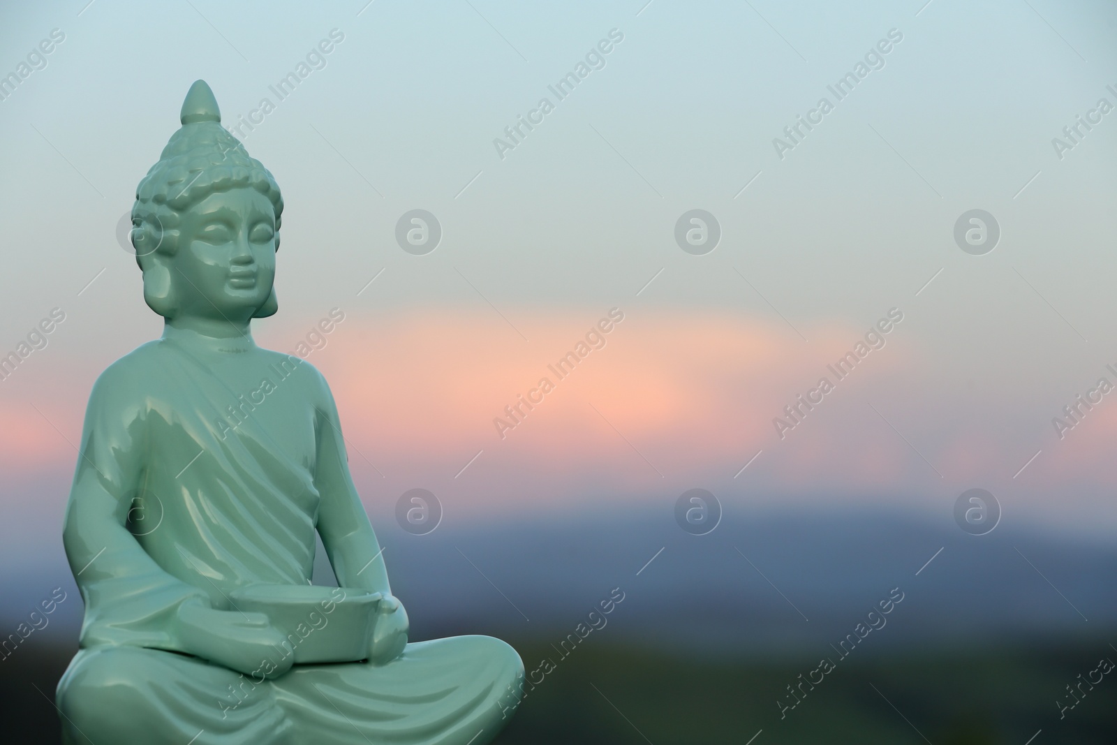 Photo of Decorative Buddha statue in mountains. Space for text