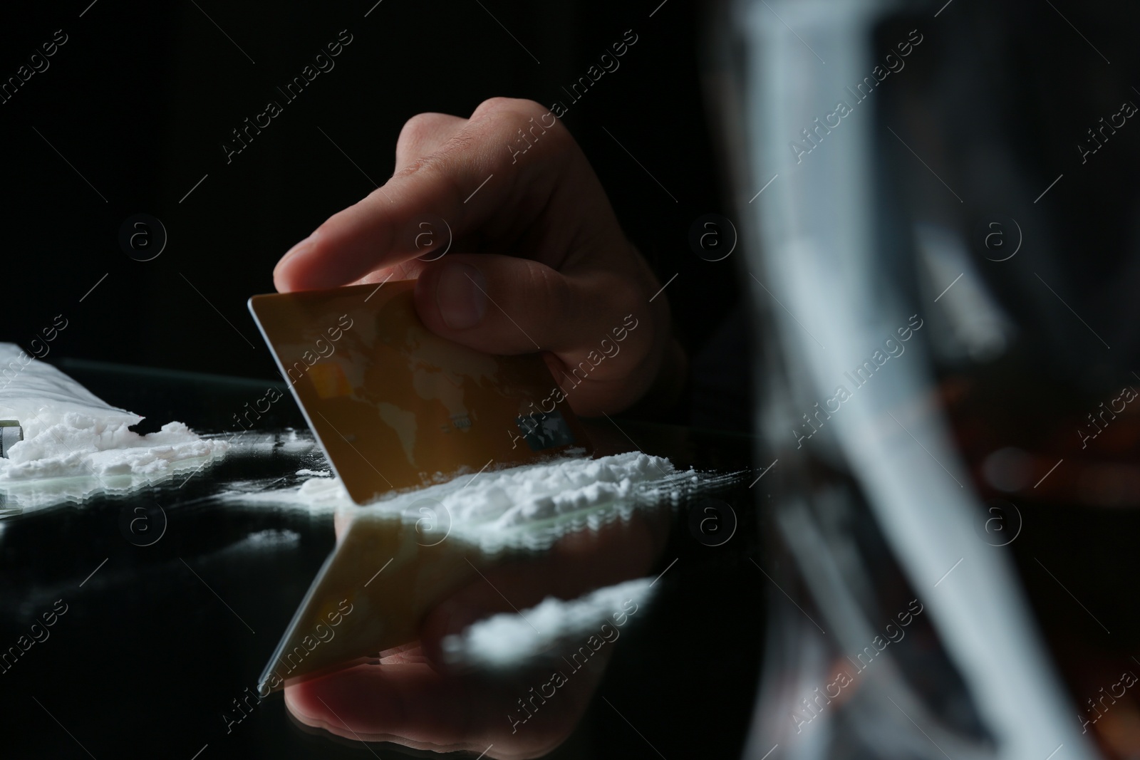 Photo of Drug addict taking cocaine at table, closeup view