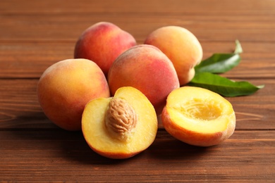 Fresh sweet peaches on wooden table, closeup