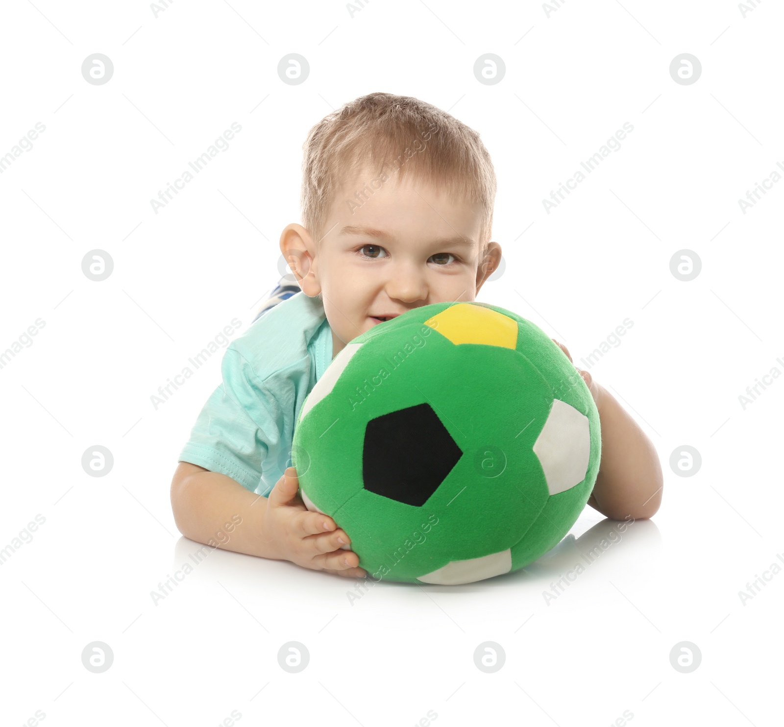 Photo of Cute little child with soft soccer ball on white background. Playing indoors