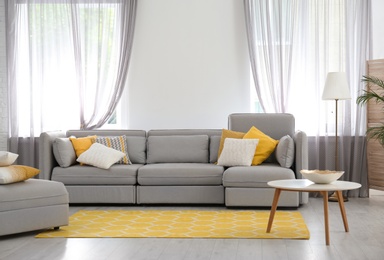 Living room with comfortable sofa and stylish decor. Idea for interior design