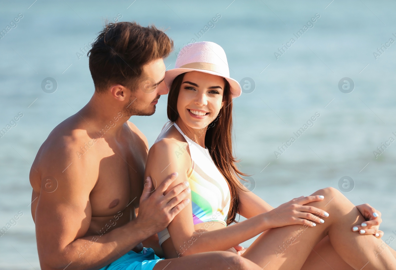 Photo of Happy young couple at beach on sunny day