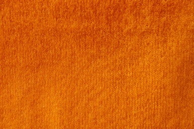 Orange knitted fabric texture as background, closeup