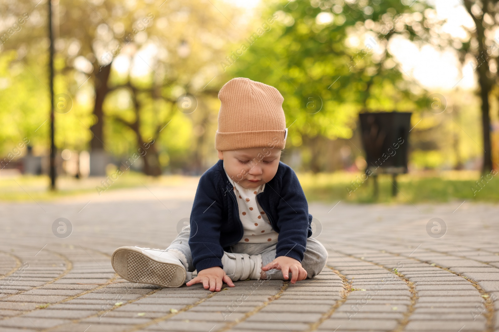 Photo of Portrait of little baby sitting in park