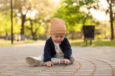 Photo of Portrait of little baby sitting in park