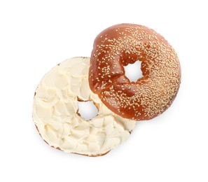 Delicious fresh bagel with cream cheese on white background, top view