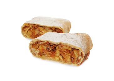 Delicious cut strudel with apples, nuts and raisins isolated on white