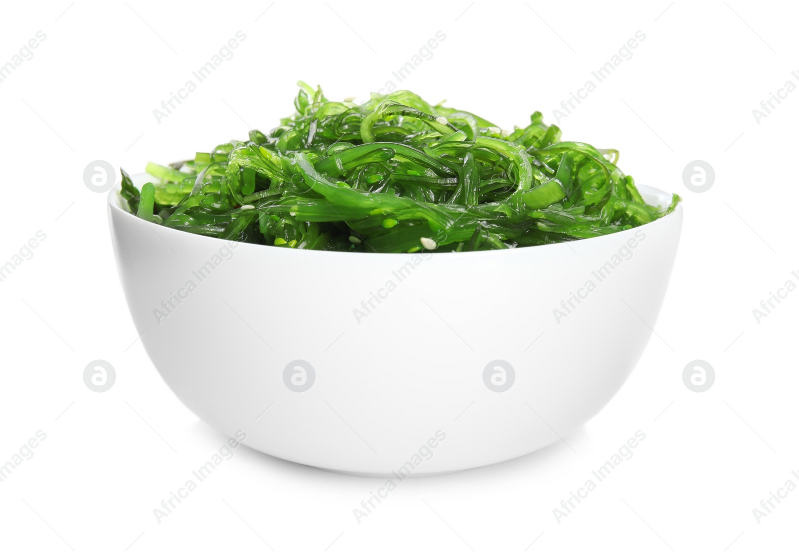 Photo of Japanese seaweed salad in bowl isolated on white