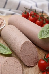 Delicious liver sausages and cherry tomatoes on table, closeup