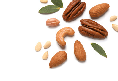 Different delicious nuts on white background, flat lay. Space for text