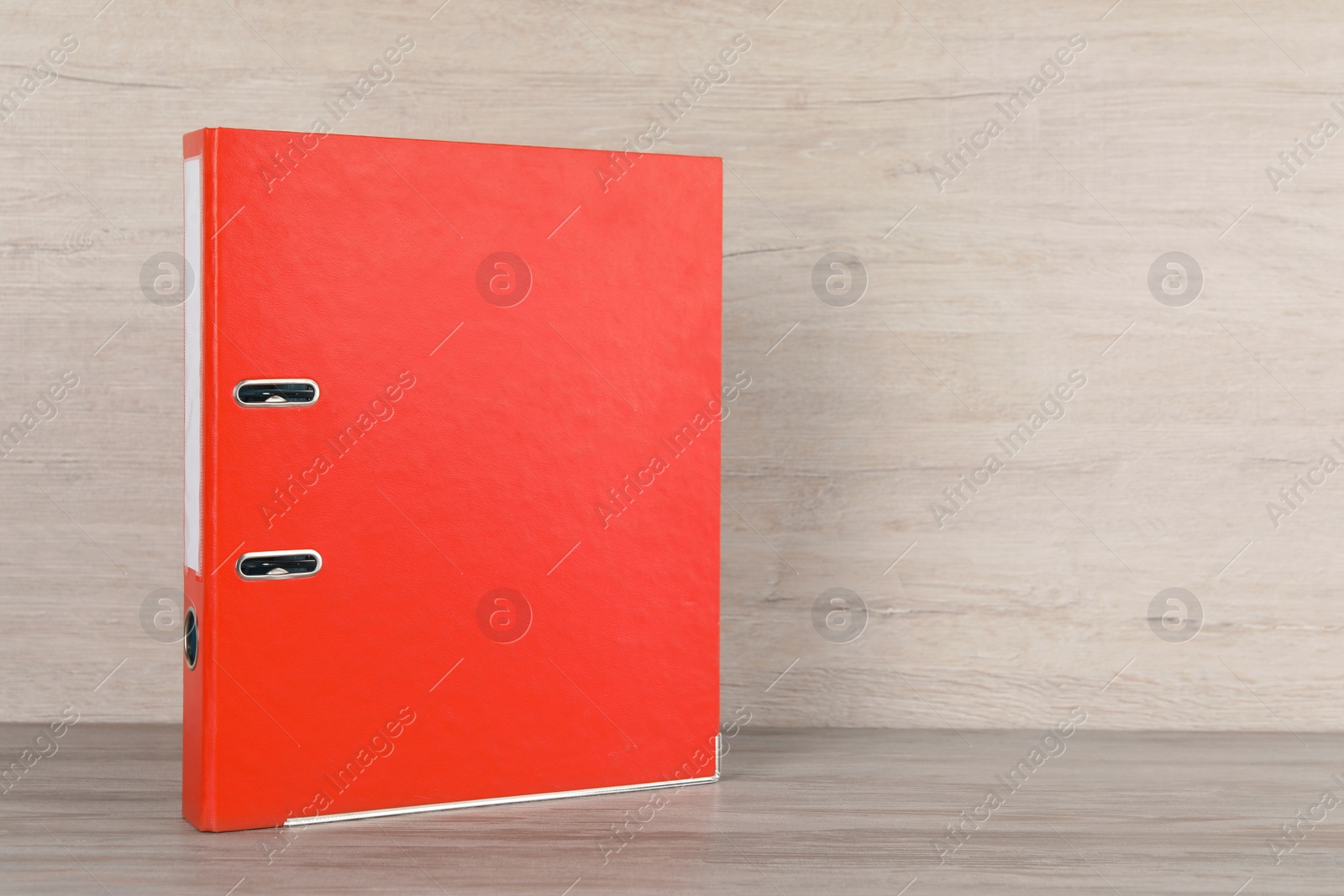 Photo of Orange office folder on white wooden table, space for text