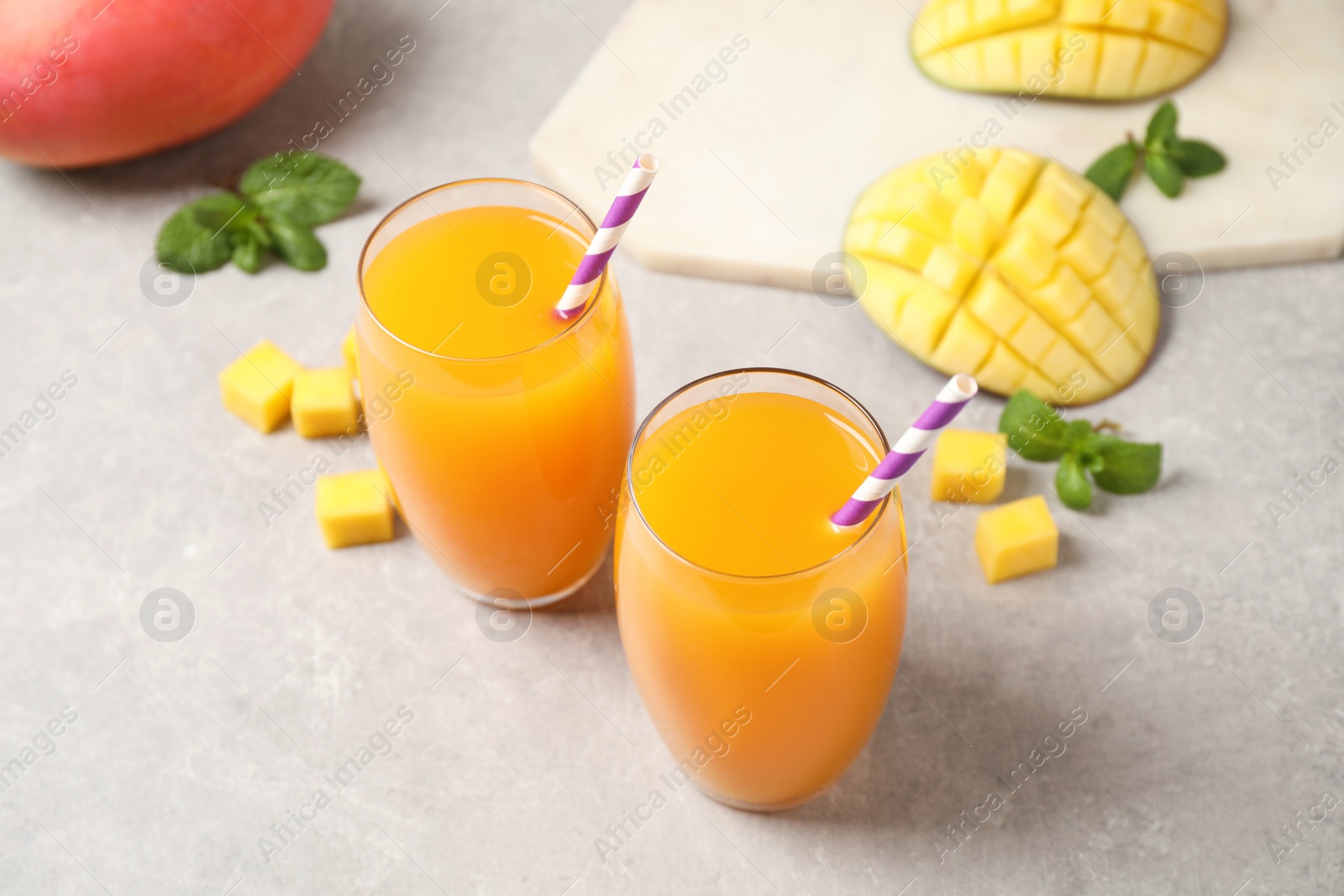 Photo of Fresh delicious mango drink on light table