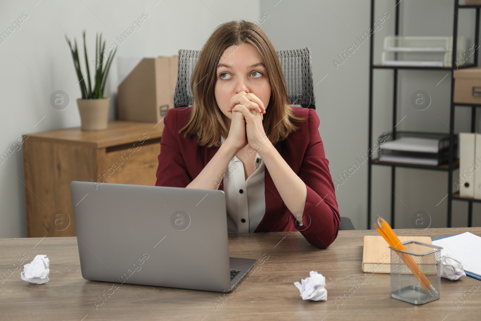 Photo of Sad businesswoman working at wooden table in office