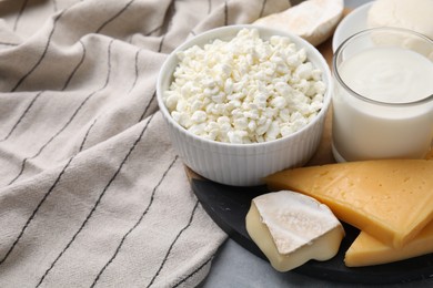 Different fresh dairy products on grey table