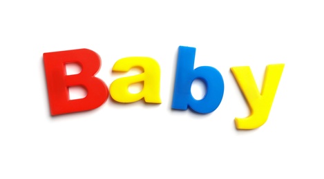 Photo of Word BABY of magnetic letters on white background, top view
