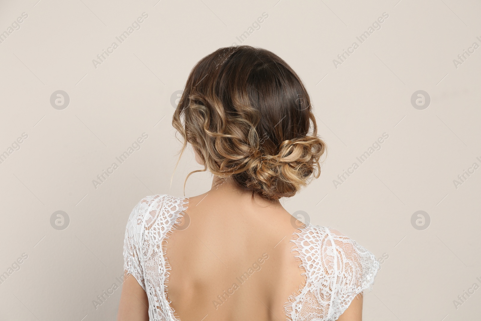 Photo of Young woman with beautiful hairstyle on beige background