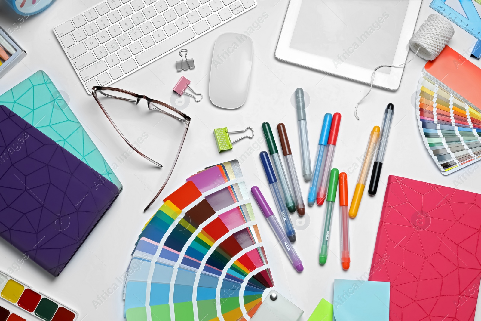 Photo of Flat lay composition with color palette and stationery on white background. Designer's workplace