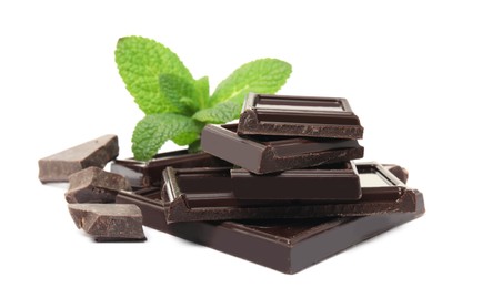 Tasty dark chocolate pieces with mint on white background