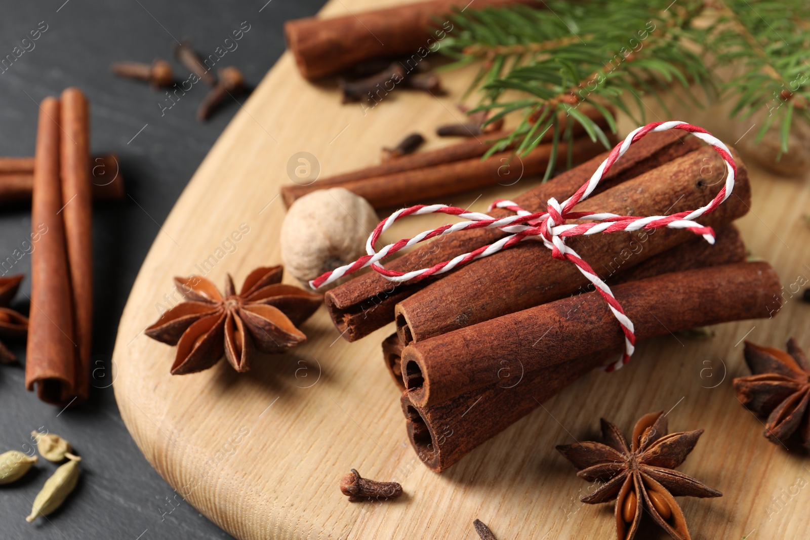 Photo of Cinnamon sticks and other spices on table, closeup