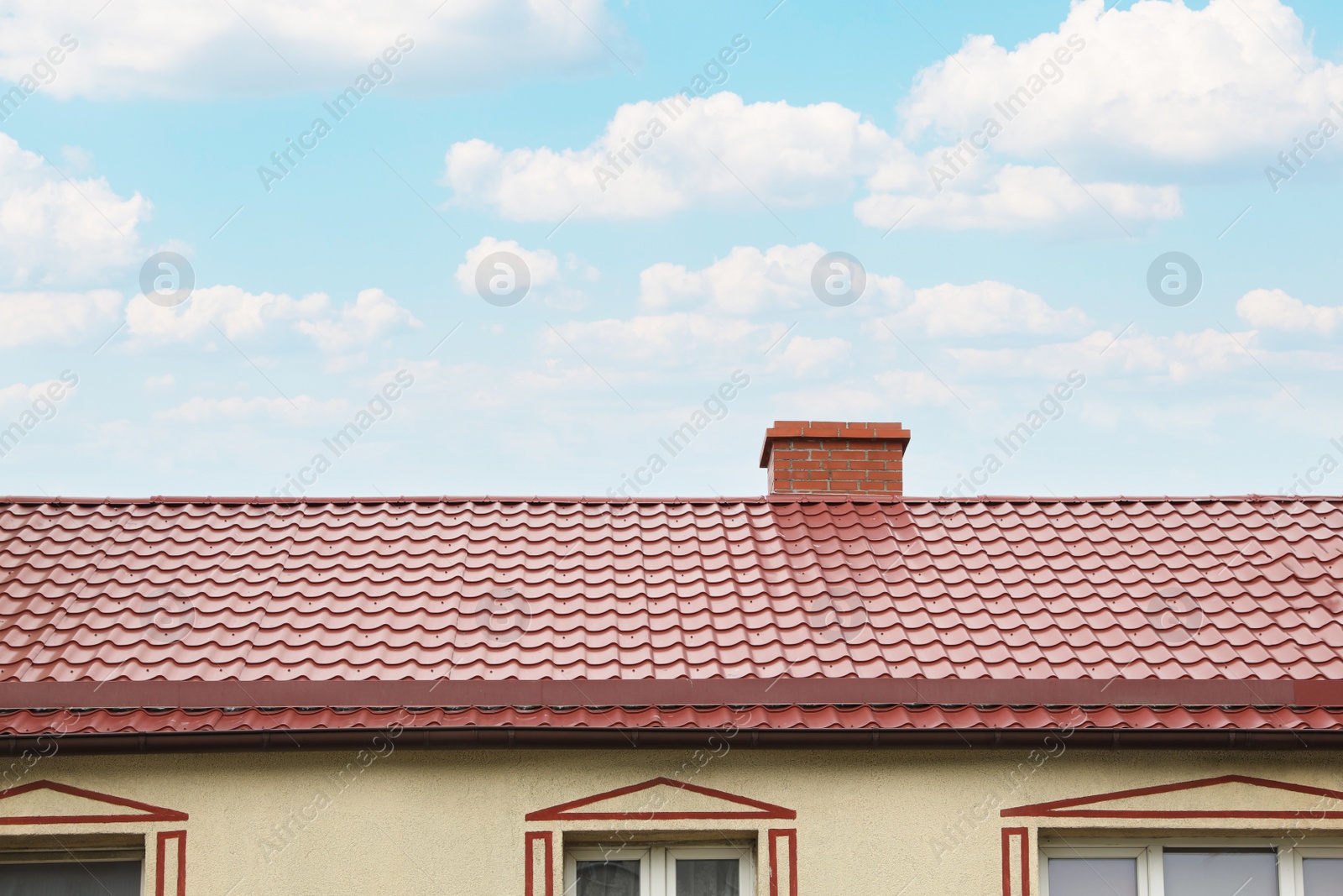 Photo of Beautiful house with red roof against blue sky, low angle view
