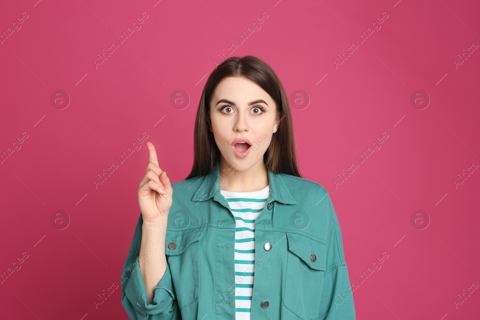Photo of Portrait of emotional young woman on pink background