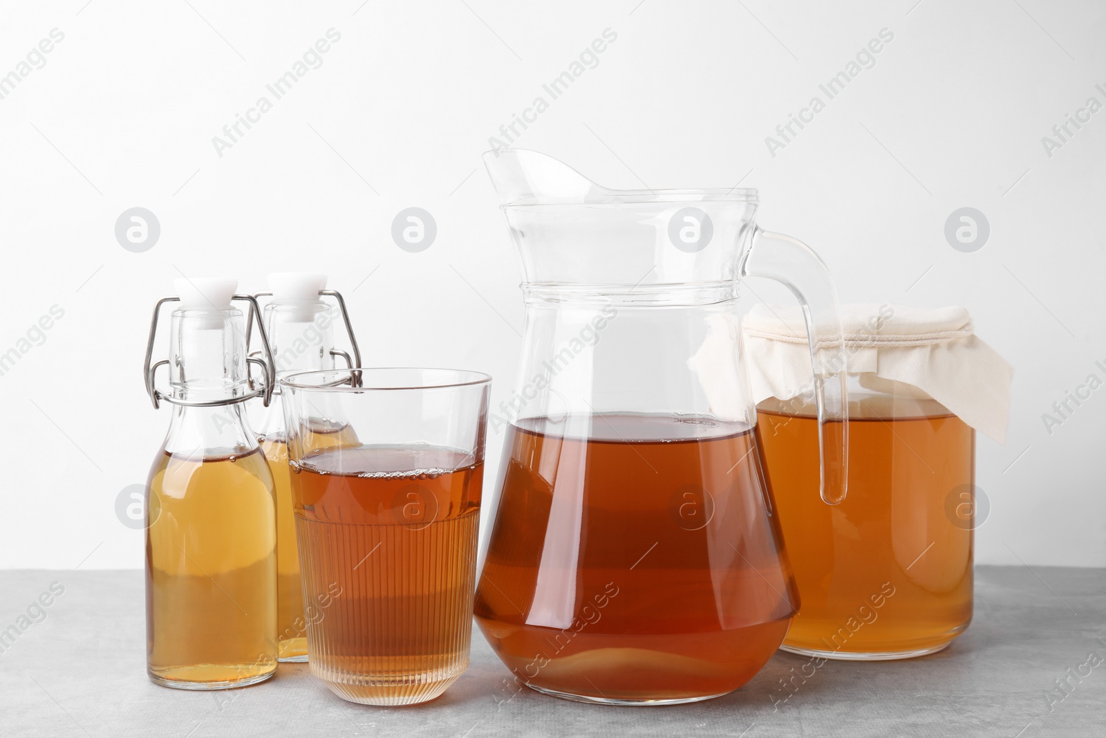 Photo of Homemade fermented kombucha on light grey table