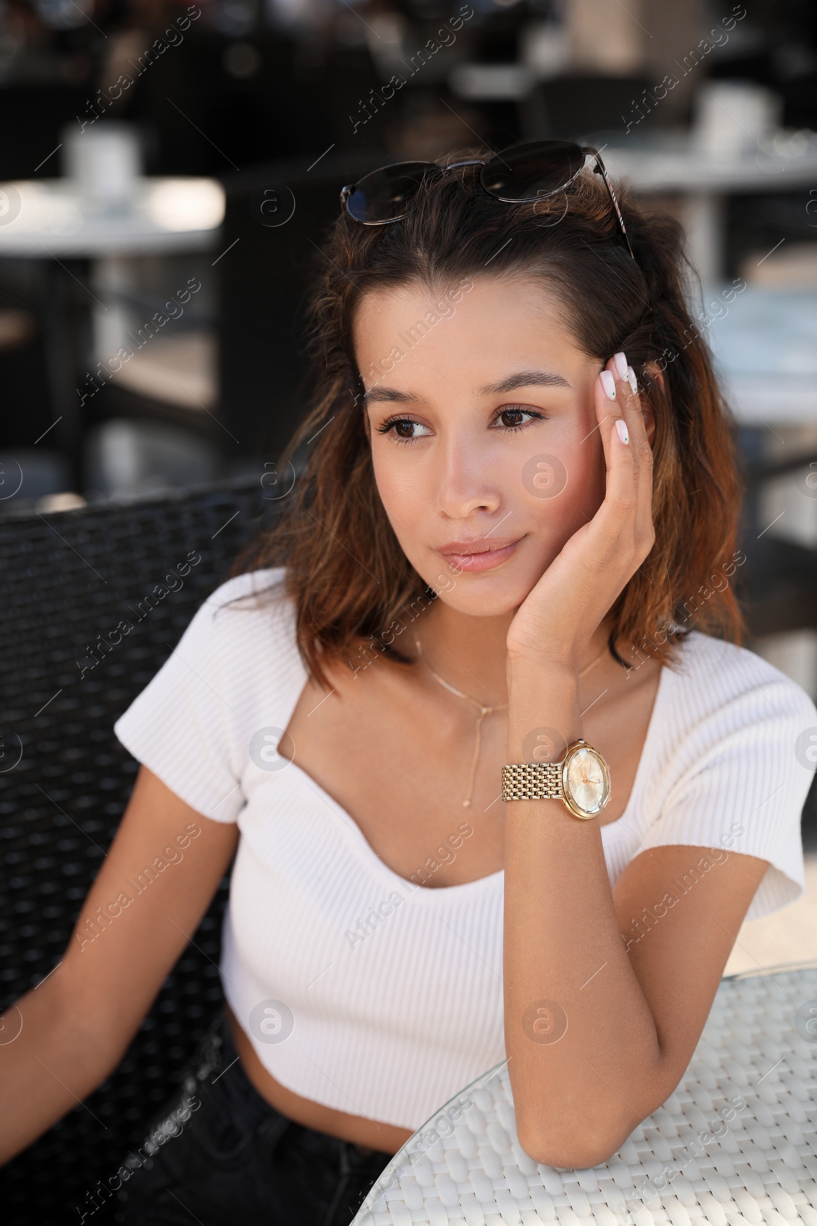 Photo of Portrait of beautiful young woman in outdoor cafe