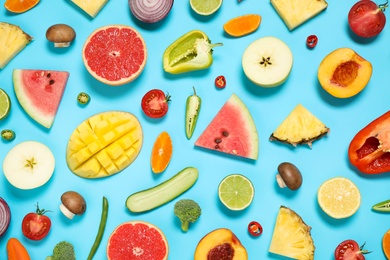 Photo of Flat lay composition with fresh organic fruits and vegetables on light blue background