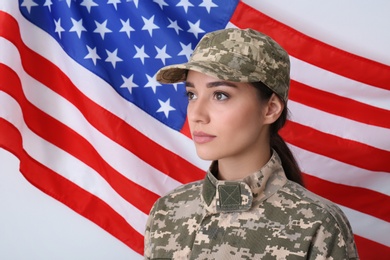 Photo of Female soldier in uniform and United states of America flag on white background