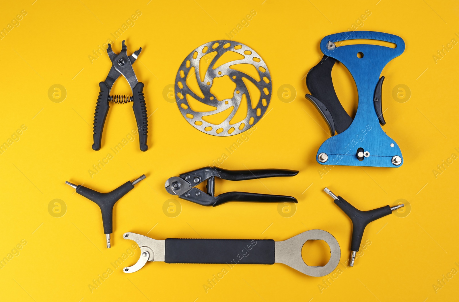 Photo of Set of different bicycle tools and part on color background, flat lay