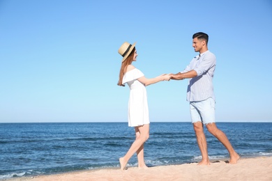 Lovely couple spending time together on beach. Space for text