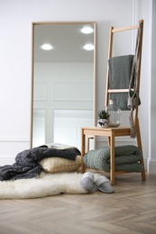 Photo of Comfortable place for rest with soft blankets and large mirror