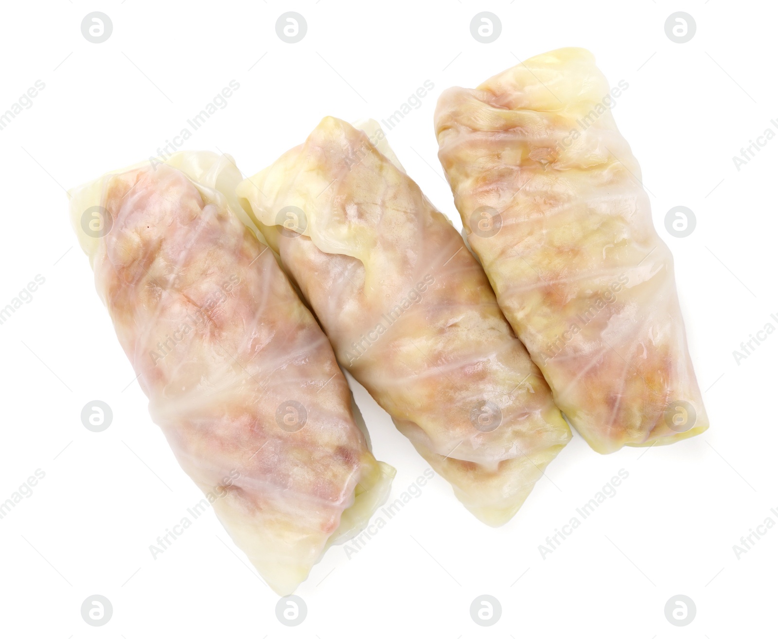 Photo of Uncooked stuffed cabbage rolls isolated on white, top view