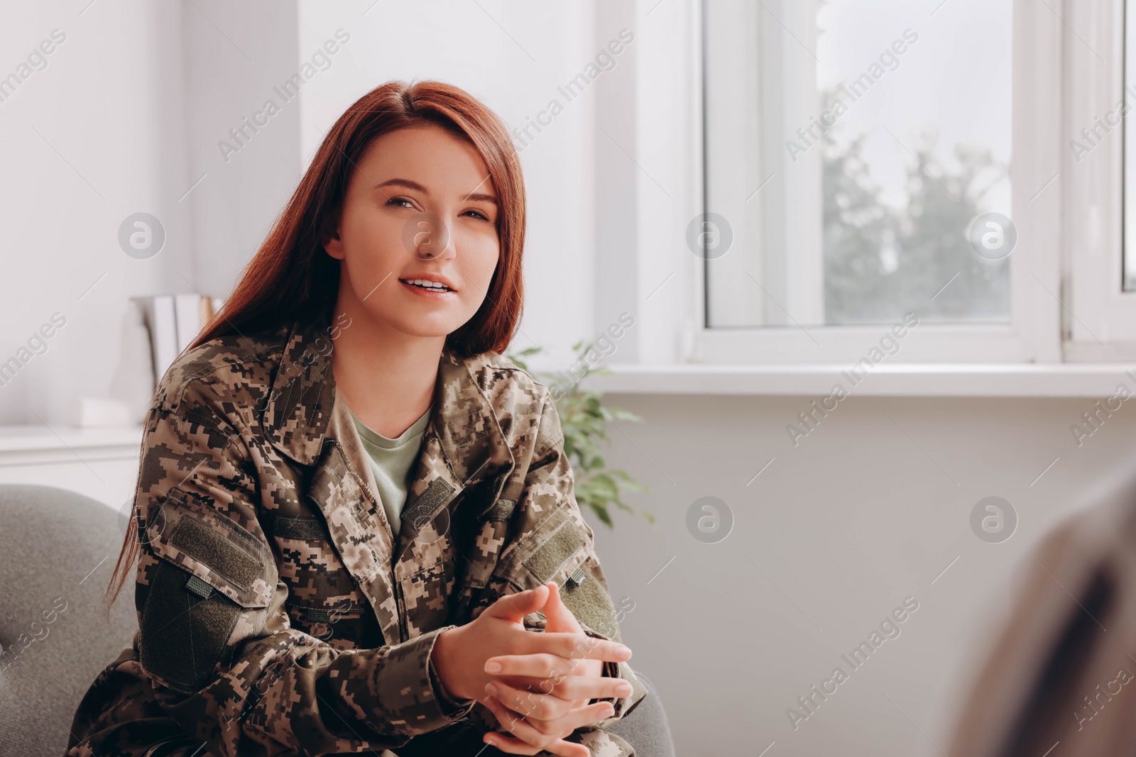 Photo of Female military officer talking with psychologist in office