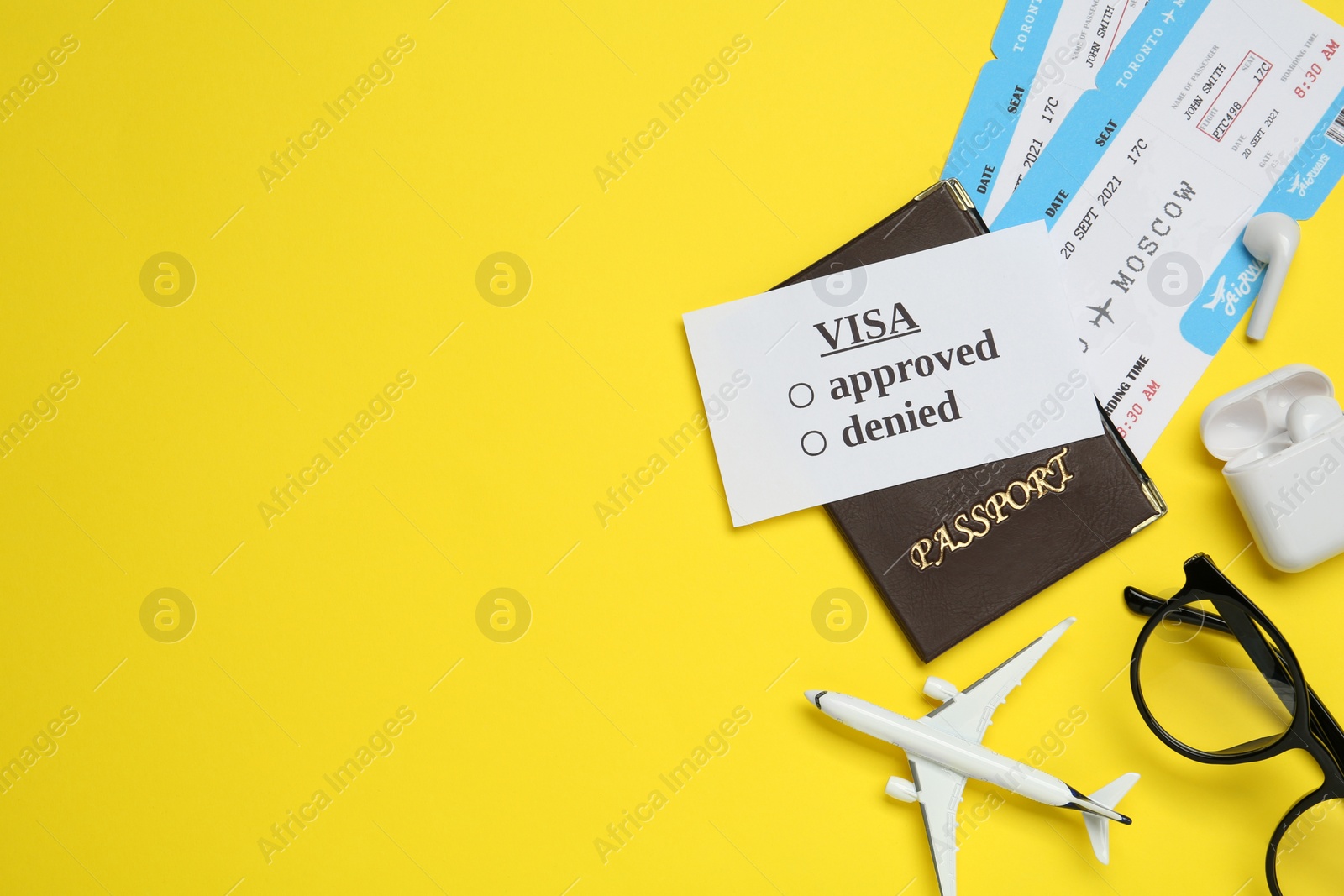 Photo of Flat lay composition with passport, toy plane and tickets on yellow background, space for text. Visa receiving