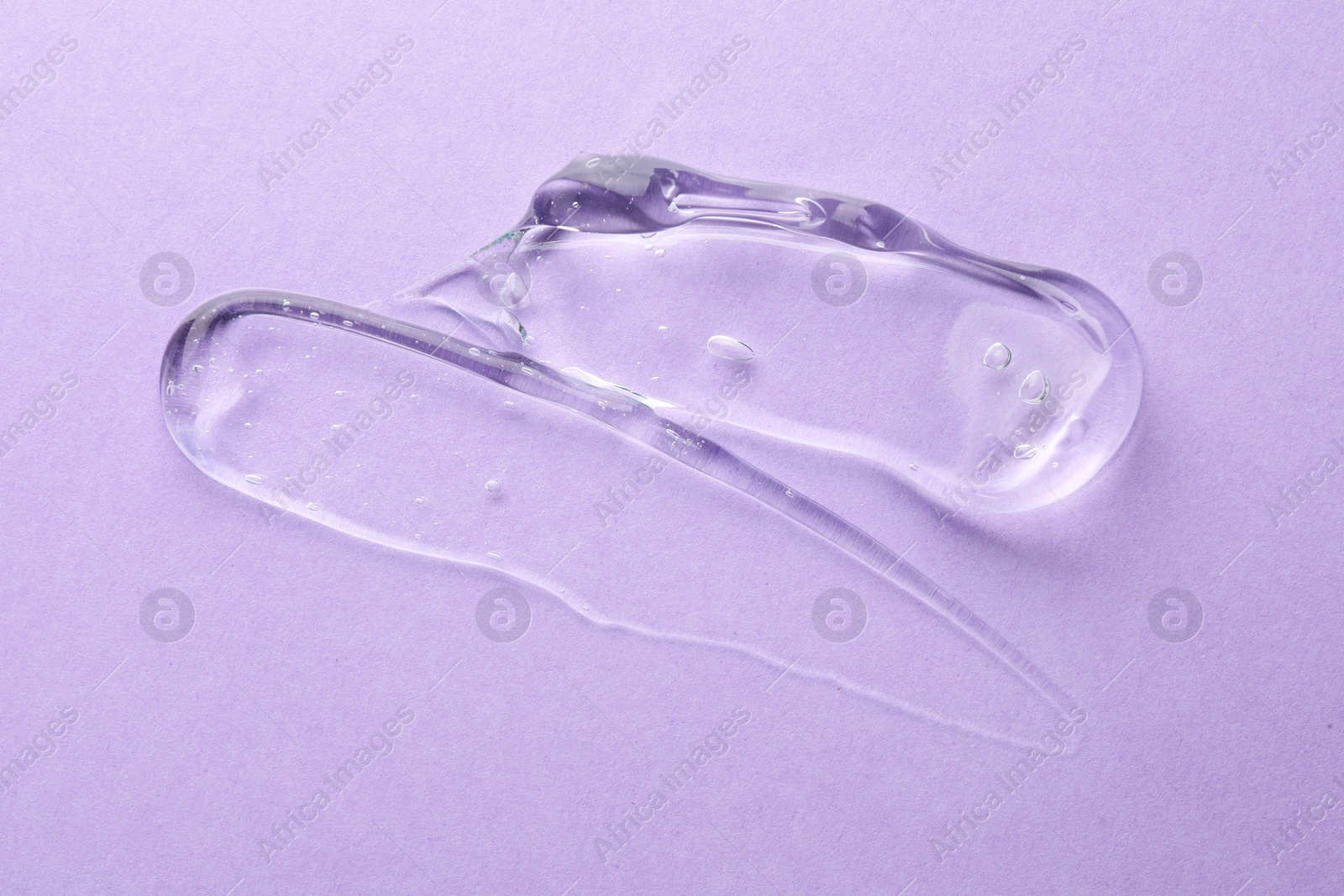 Photo of Clear cosmetic gel on violet background, top view