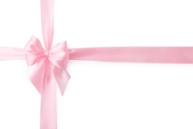 Pink satin ribbon with bow isolated on white, top view