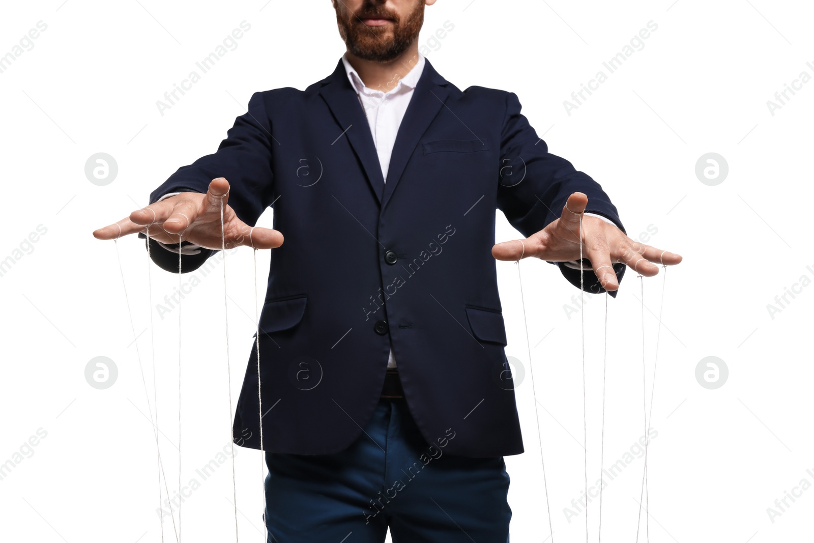 Photo of Man in suit pulling strings of puppet on white background, closeup