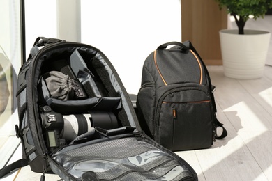 Backpacks with professional photographer's equipment indoors